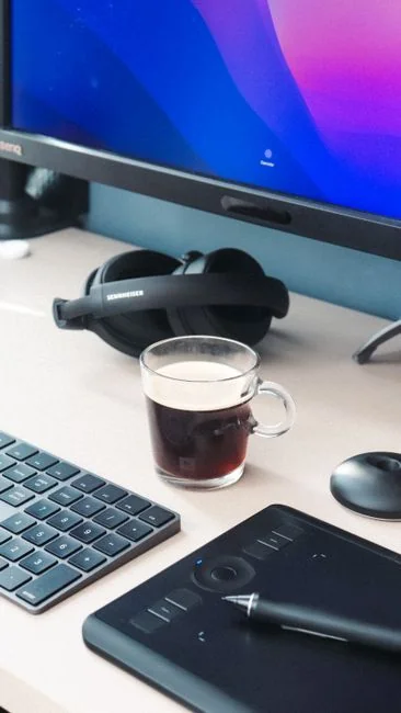 A polished and productive workspace with several monitors, a laptop, and a smartphone, displaying a web design project.